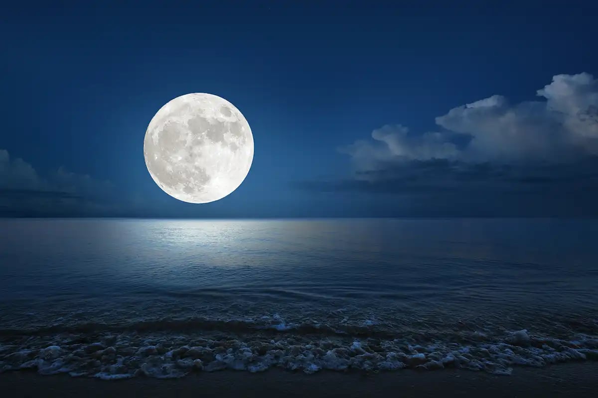 Supermoon over a lake at night
