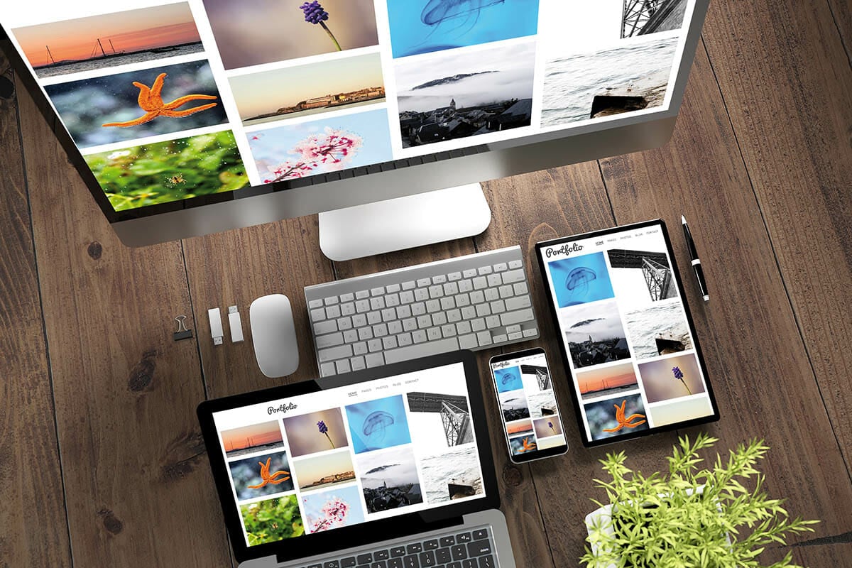 3d rendering top view of devices with portfolio on screen on wooden desktop