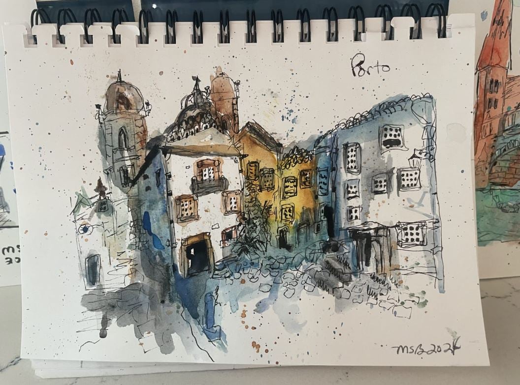 Urban sketch of a Porto street scene in a spiral sketchbook, by student Mary Baldree.