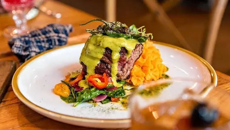 Carne Asada steak with poblano sauce, mashed sweet potatoes, and sautéed vegetables—captured for Idaho food photography in Boise and the Treasure Valley.