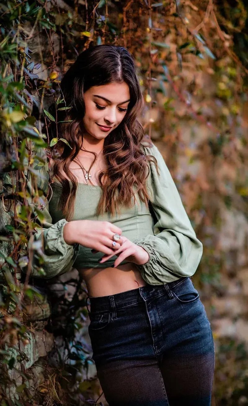 High School Senior Portrait: Senior Leaning on Ivy Wall