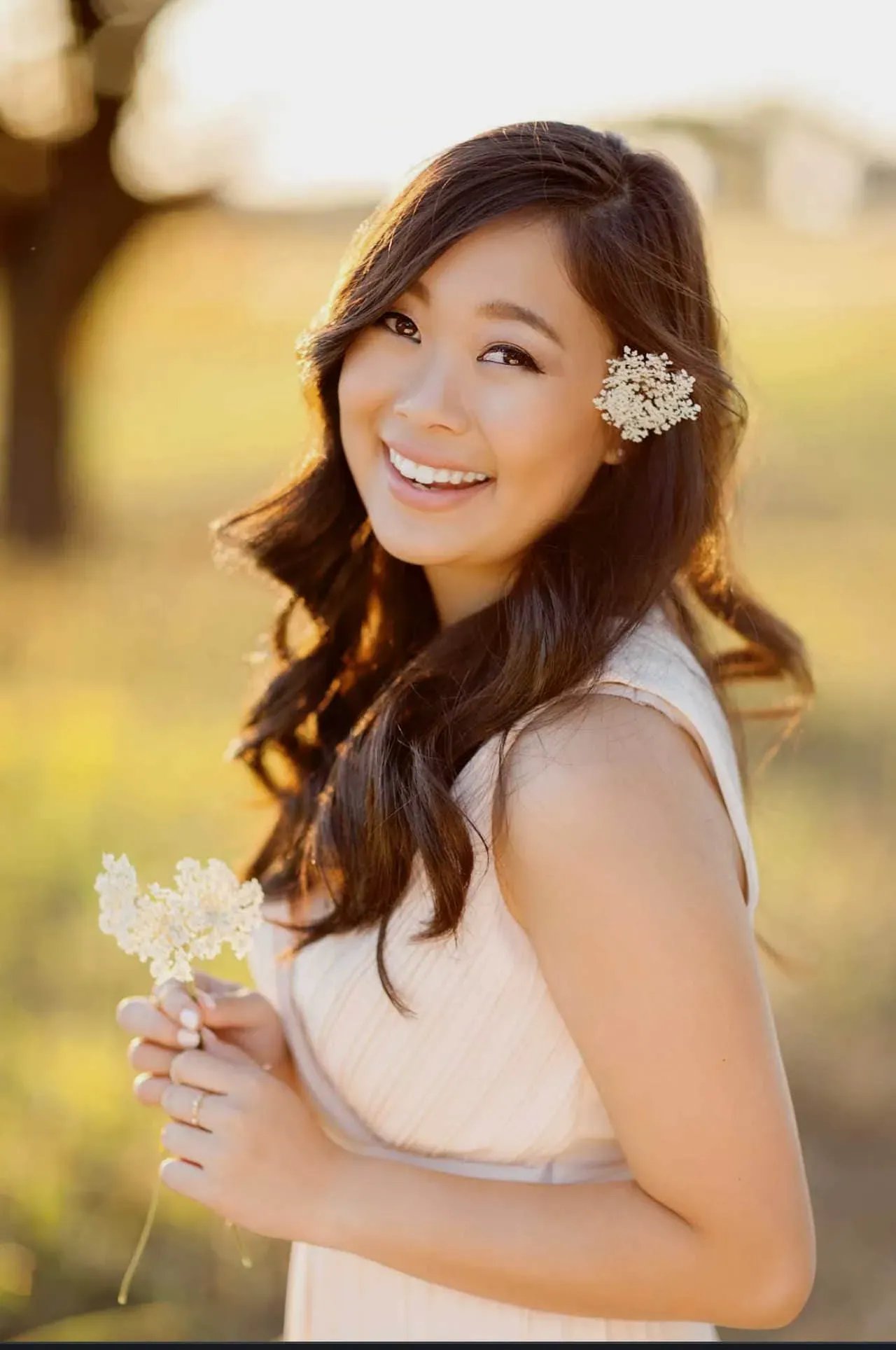 High School Senior Portrait: Senior in Field with Flower in Hair