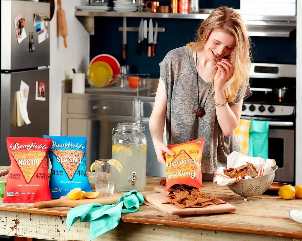 Young person enjoying chips at a rustic kitchen counter with lemonade and product display—captured for Idaho advertising photography in Boise and the Treasure Valley.