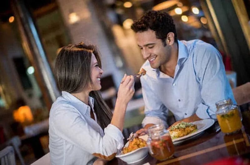 Two people sharing a joyful meal in a cozy Idaho restaurant—captured for Boise food photography in the Treasure Valley.