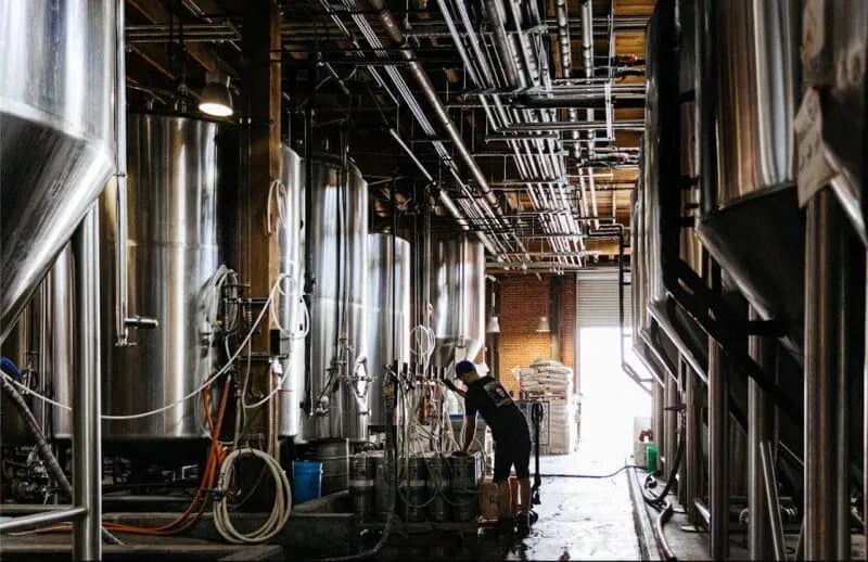 Industrial production facility with stainless steel processing tanks photographed by Idaho Photography Studios.