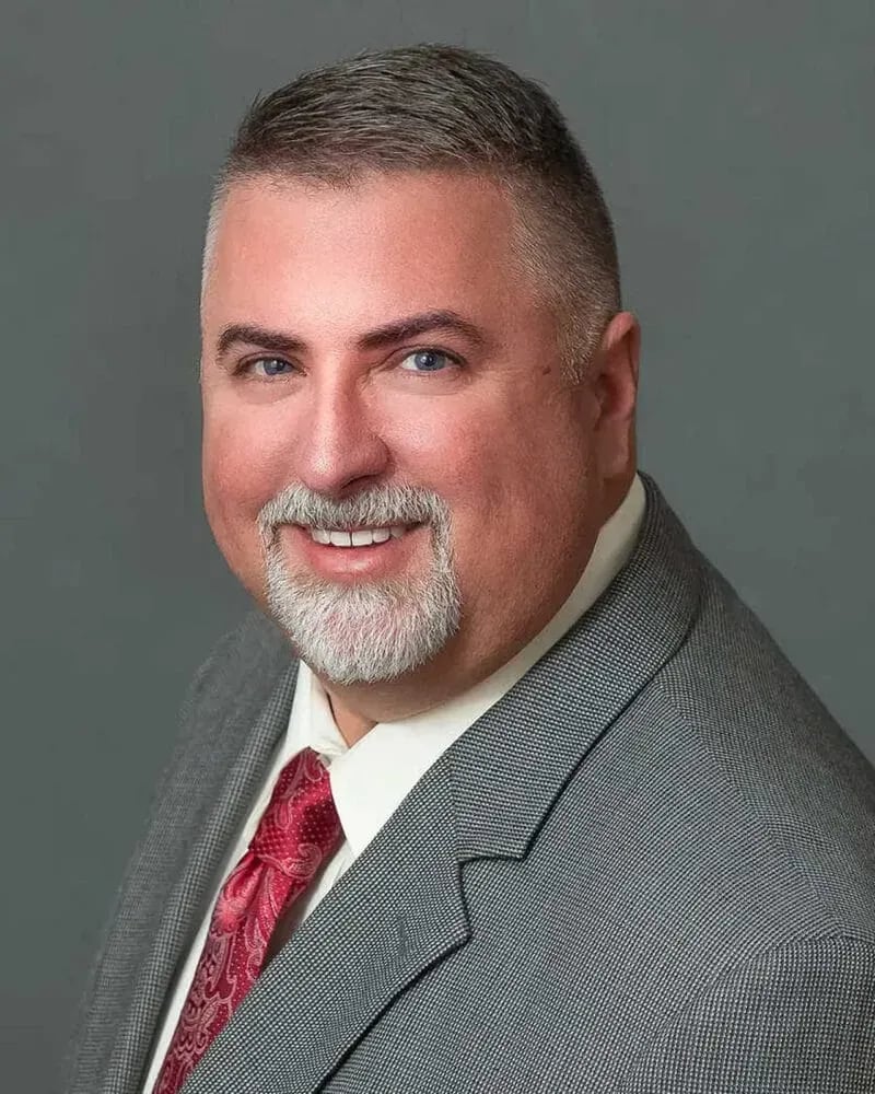 Attorney Headshot: Attorney in Grey Suit