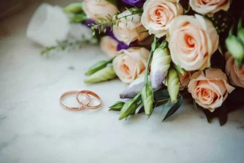 Wedding Rings: Wedding Rings in Front of Flowers