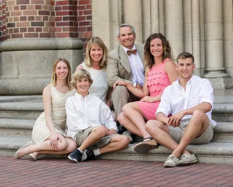 Family portrait session on the steps of a Caldwell church by Idaho Photography Studios, featuring warm natural light and timeless composition.