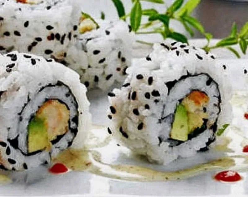 California sushi rolls with avocado, crab, and cucumber, garnished with sesame seeds and sauces—captured for Idaho food photography in Boise and the Treasure Valley.