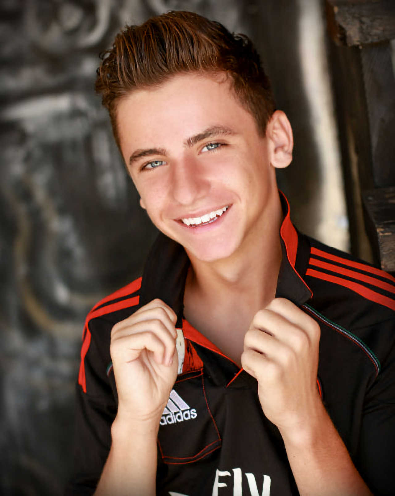 Rocky Mountain High School senior portrait in black Adidas jersey with confident athletic studio styling