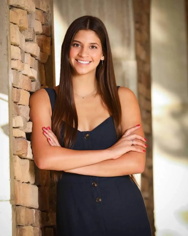 High School Senior Portrait: High School Gal Leaning on Brick Wall
