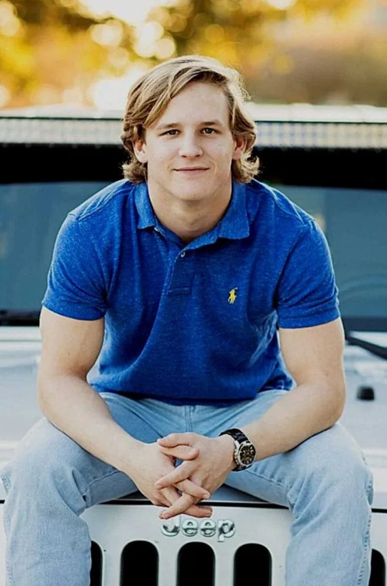 High School Senior Portrait: Senior Sitting on Hood of Jeep