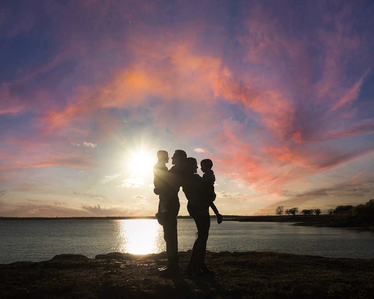 Silhouette of Family Against a Setting Sun