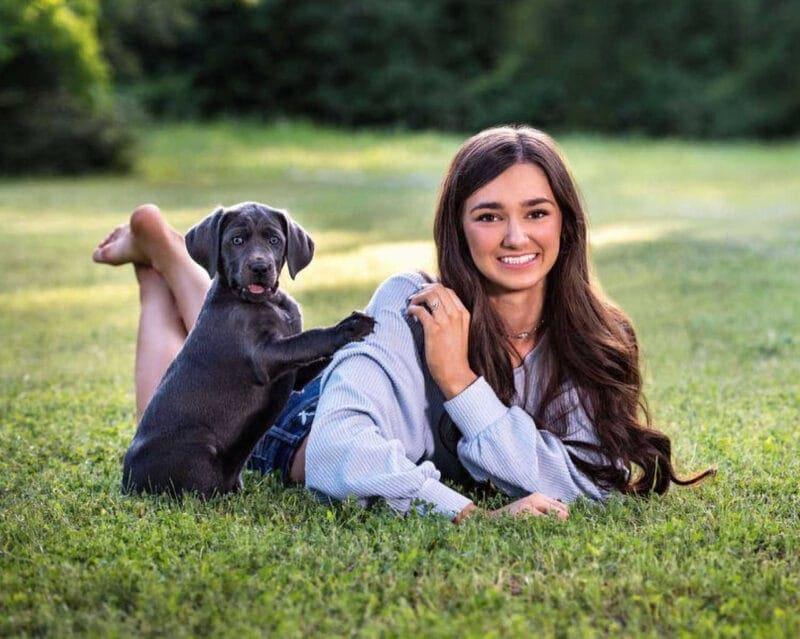 High School Senior Portrait: High School Senior Girl Lying in Park with Her Dog