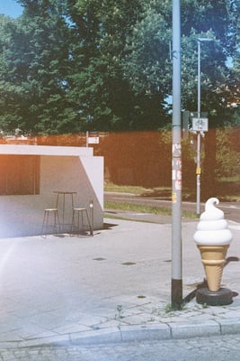 a statue of an ice cream cone in front of a kiosk