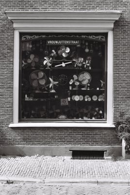 a window with a display of fan blades