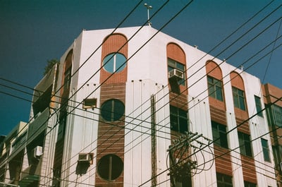a building with persony windows against a blue sky