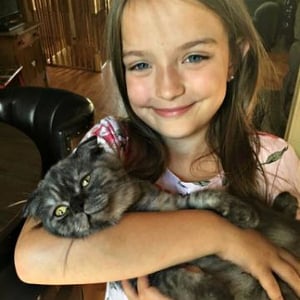 A cat in the arms of a child