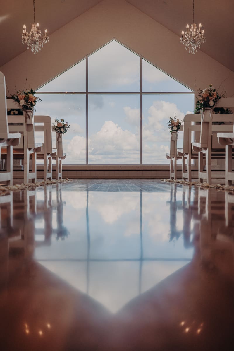 Empty chapel aisle. Getting ready photos by She Said Yes.
