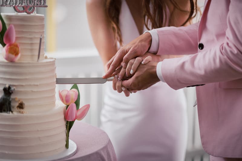 Olivia the bride and Jake the groom cut their wedding cake together at White Horse Ranch.