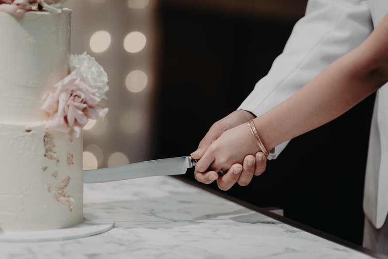 The bride and groom cut their wedding cake together at the reception in Royal on the Park.