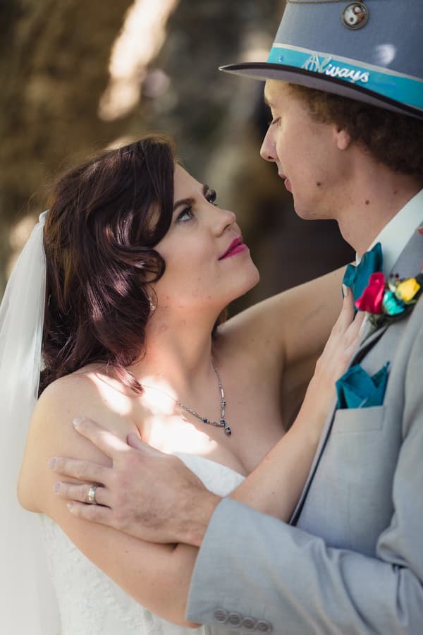 Bride Holly and groom Paul embrace and gaze into each other's eyes at Kwila Lodge.