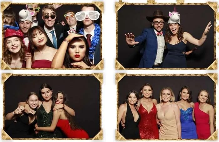 Guests posing with props against the black photo booth backdrop