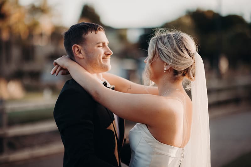 Bride Libby and groom Kyle embrace during their couple portraits session at The Tides.