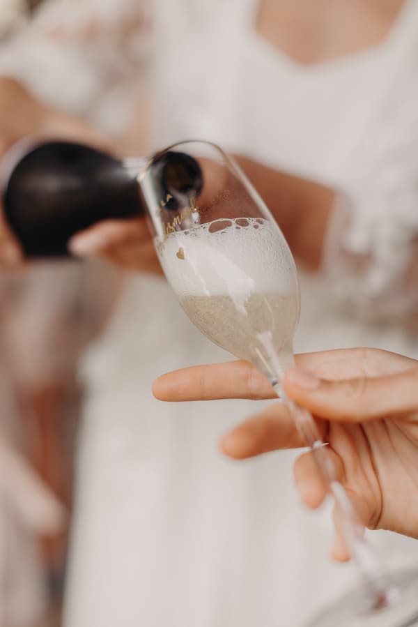 A close-up of champagne being poured into a flute glass at Preston Peak Winery Functions Centre.