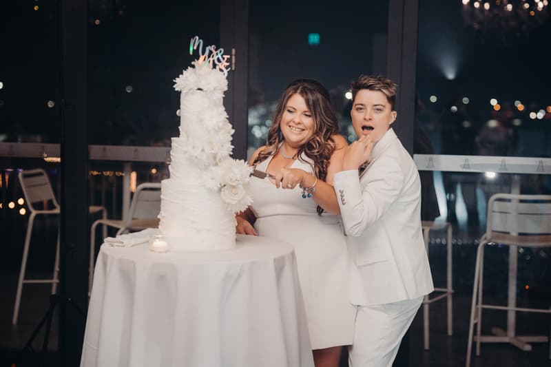 Brides Brooke and Tiffany cut their wedding cake together at the reception in the Pumicestone Room at Sandstone Point Hotel.