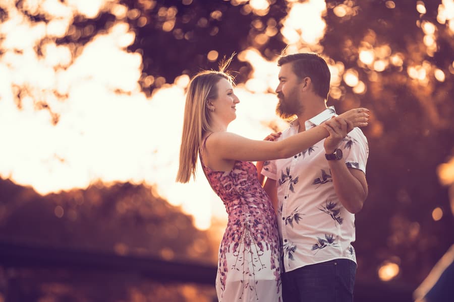 The couple gazing at each other lovingly, surrounded by trees at Brisbane Powerhouse.