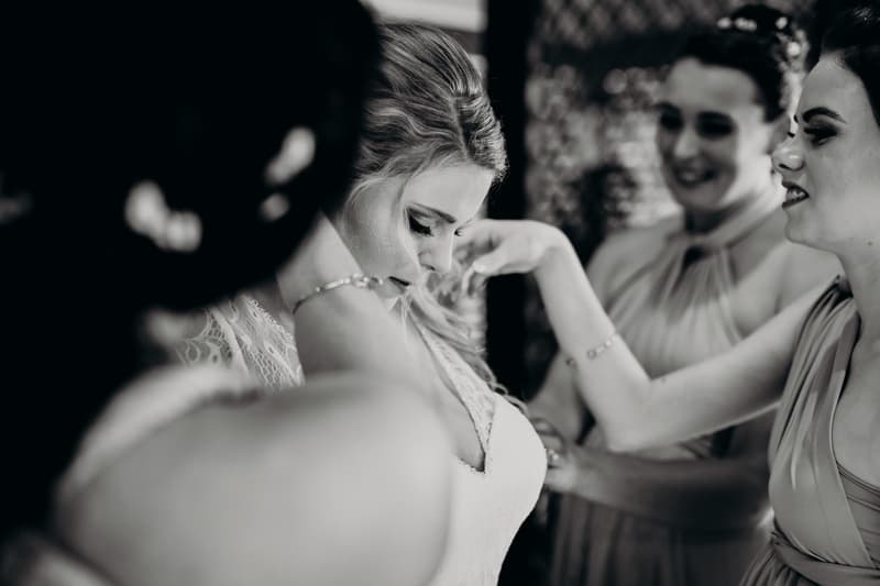 The bride Annie is assisted by bridesmaids as she prepares for the wedding at Ocean View Estates.