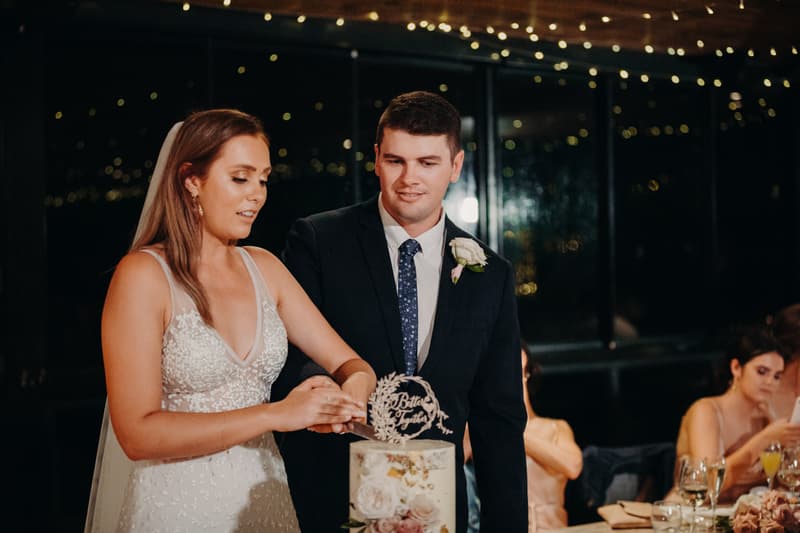 Chelsea and Brent cut their wedding cake together at Preston Peak Winery Functions Centre during the reception.