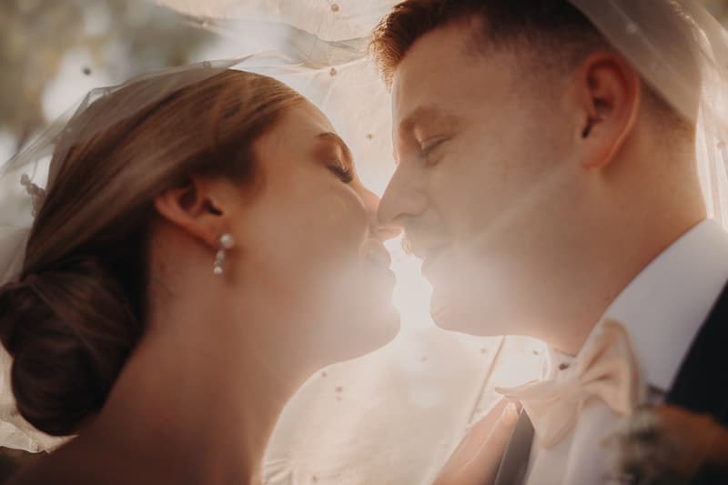 Bride Courtney and groom Liam pose closely under the bride's veil at Tiffany's Maleny during their couple portraits session.