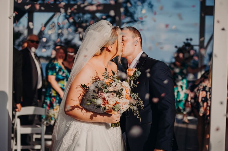 Emily and Dylan kiss at the. Event videographer Brisbane by She Said Yes.