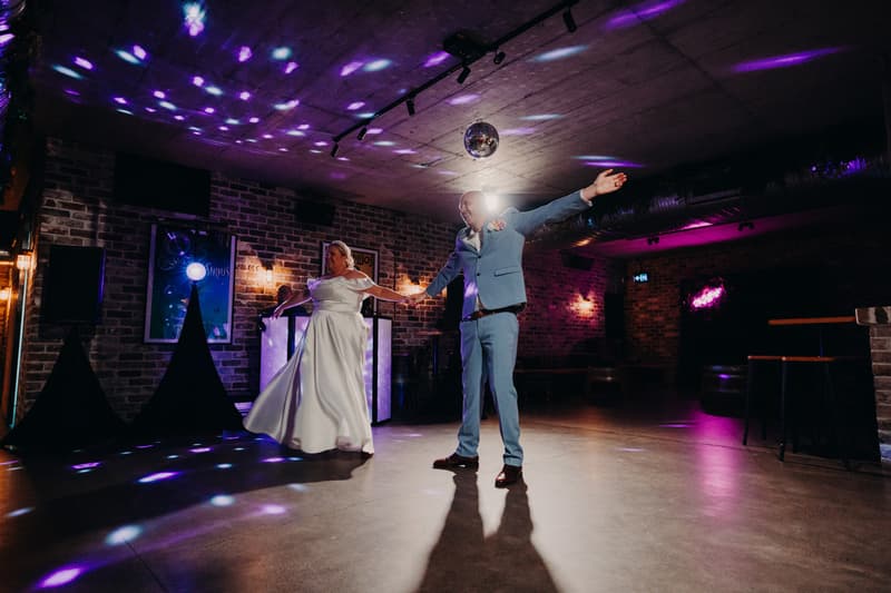 Bride Jacquelyne and groom Arran dance together on the dance floor at the Sandstone Point Hotel — Cellar during the reception.