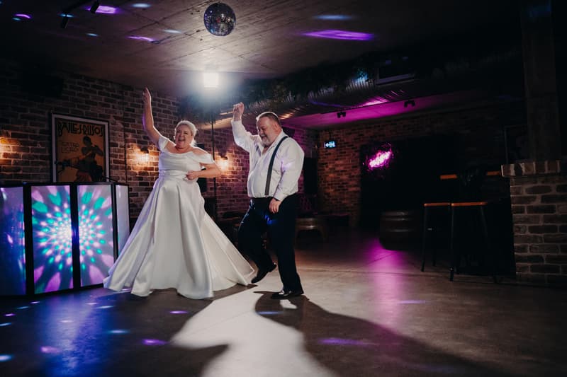 Bride Jacquelyne and groom Arran dance together on the floor at Sandstone Point Hotel — Cellar during the wedding reception.