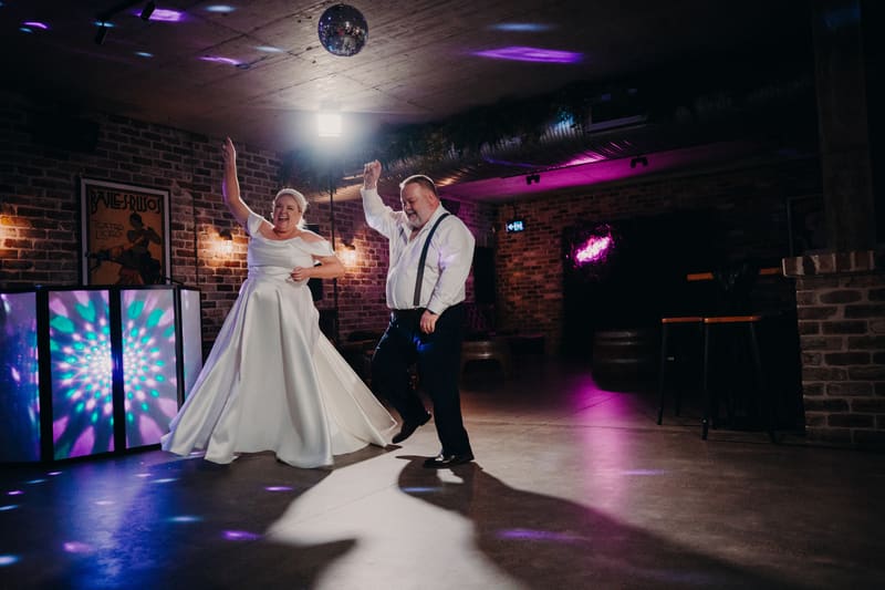 Bride Jacquelyne and groom Arran dance together on the floor. Wedding live streaming by She Said Yes.