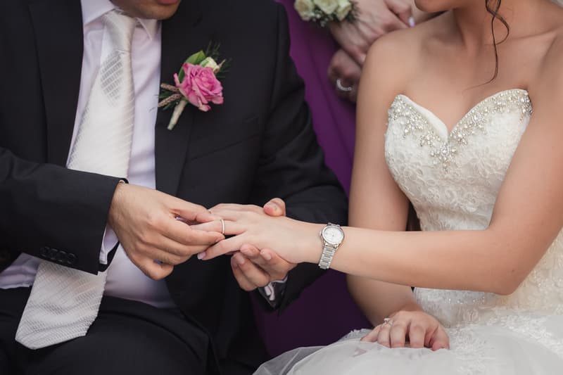 Pasha places a wedding ring on Maryam's finger during the ceremony at Hillstone St Lucia — The Quartyard.