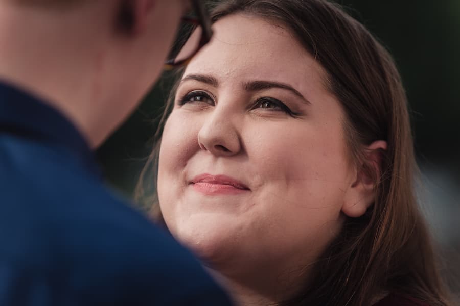 Close-up of one person gazing affectionately at the other, with a soft focus background.