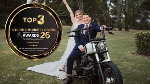 Kierra and Jarrod celebrating on a motorbike after their Sandstone Point Hotel wedding, with the 2026 Brisbane Wedding Industry Awards Top 3 roundel