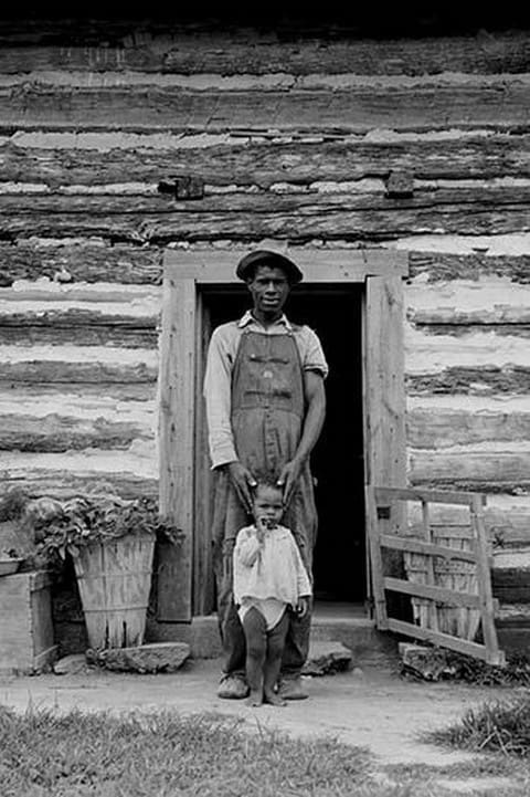 Young sharecropper and his first child by Dorothea Lange - Art Print