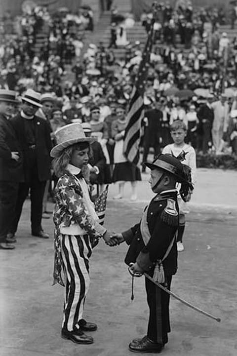 Costumed Child dressed as Uncle Sam welcomes another toddler representing the Italian community of the United States for an Italy-American Friendship Even held in New York City - Art Print