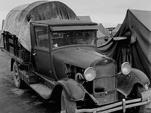 Truck Parked by Tent in FSA site by Dorothea Lange - Art Print
