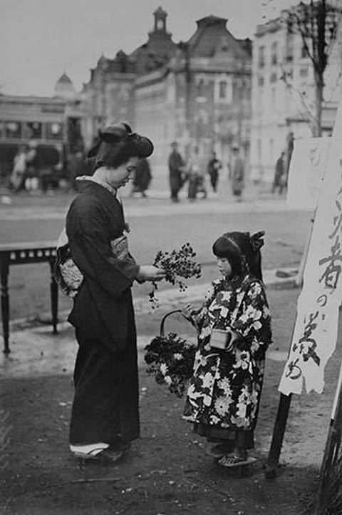 Toddler in front of Shop sign sells flowers to a kimono wearing young lady - Art Print
