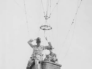 Balloon jump by a parachutist hanging from a basket suspended by it but out of the image. - Art Print