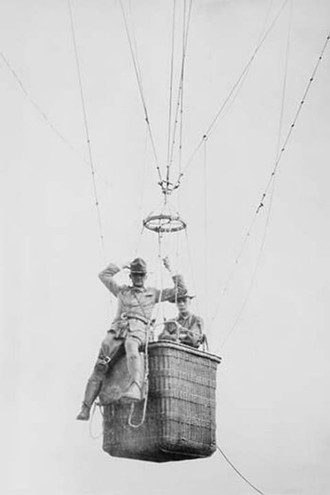 Balloon jump by a parachutist hanging from a basket suspended by it but out of the image. - Art Print