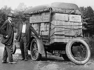 Agents capture a vehicle loaded with liquor as it got a flat tire - Art Print