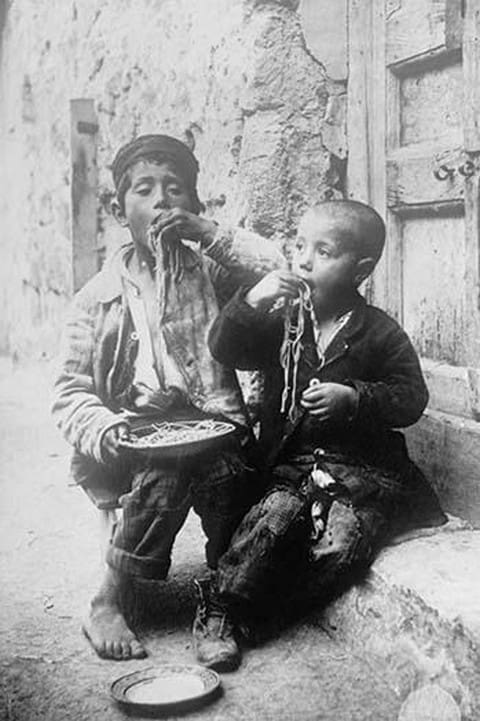 Two Neapolitan Children slurp down Spaghetti - Art Print