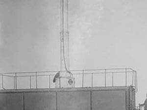 A Train Carries a man 10 stories aloft on what looks like a Chimney - Art Print